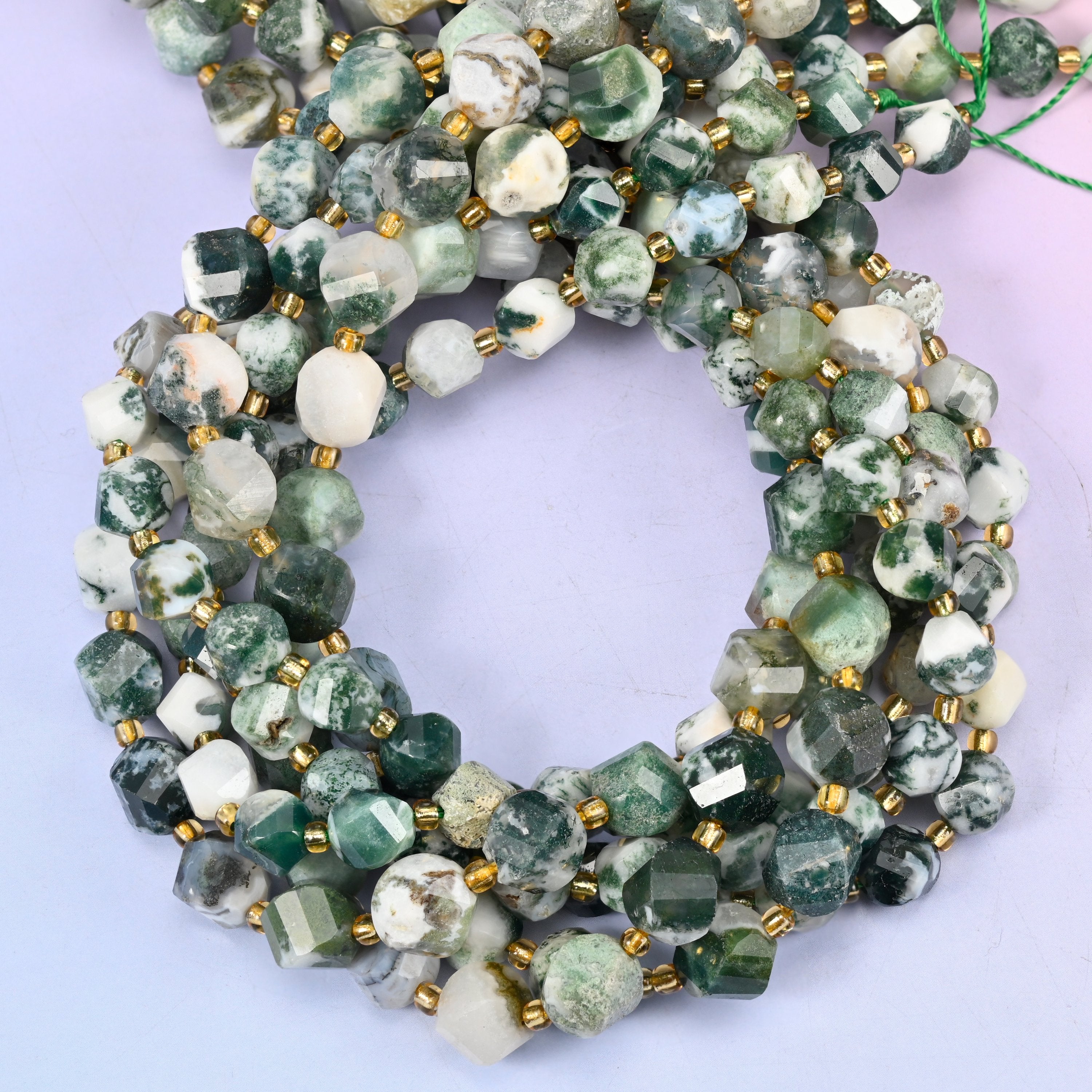 Tree Agate faceted spiral twist beads, close view of the coiled strands showing white with deep green dendritic markings
