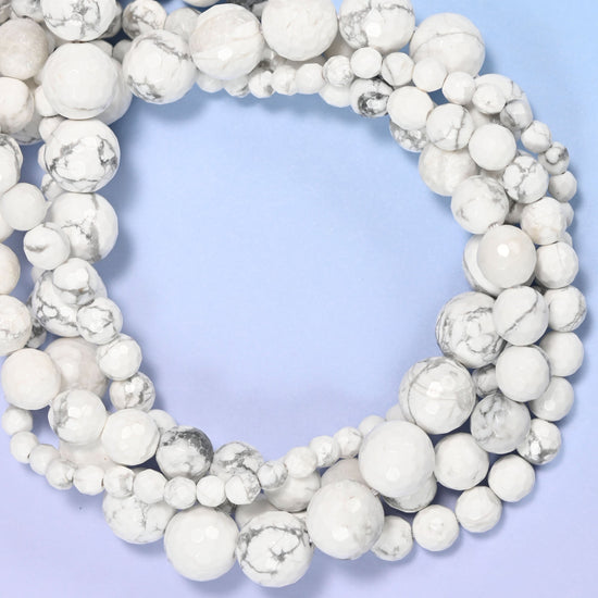 White Howlite faceted round beads, close view of the coiled strands showing white with grey veining