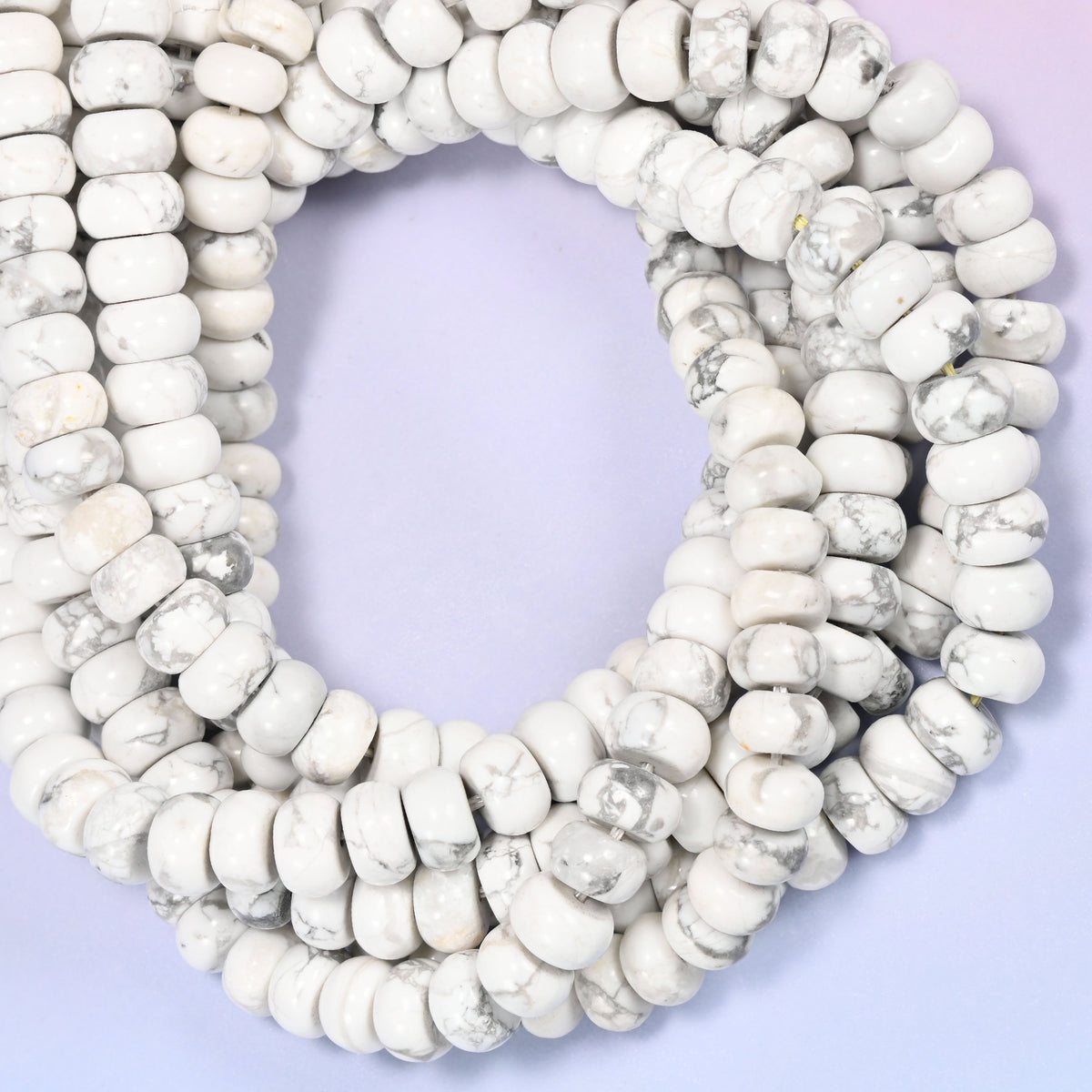White Howlite rondelle beads, close view of the coiled strands showing white with grey veining
