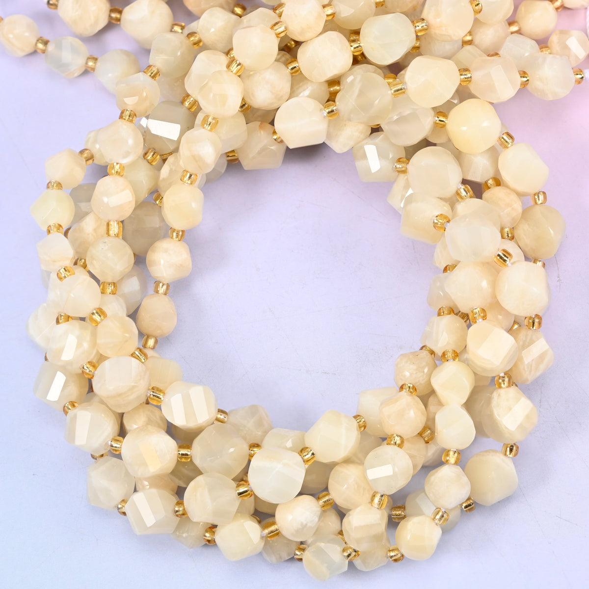 White moonstone faceted spiral twist beads, close view of the coiled cream strands