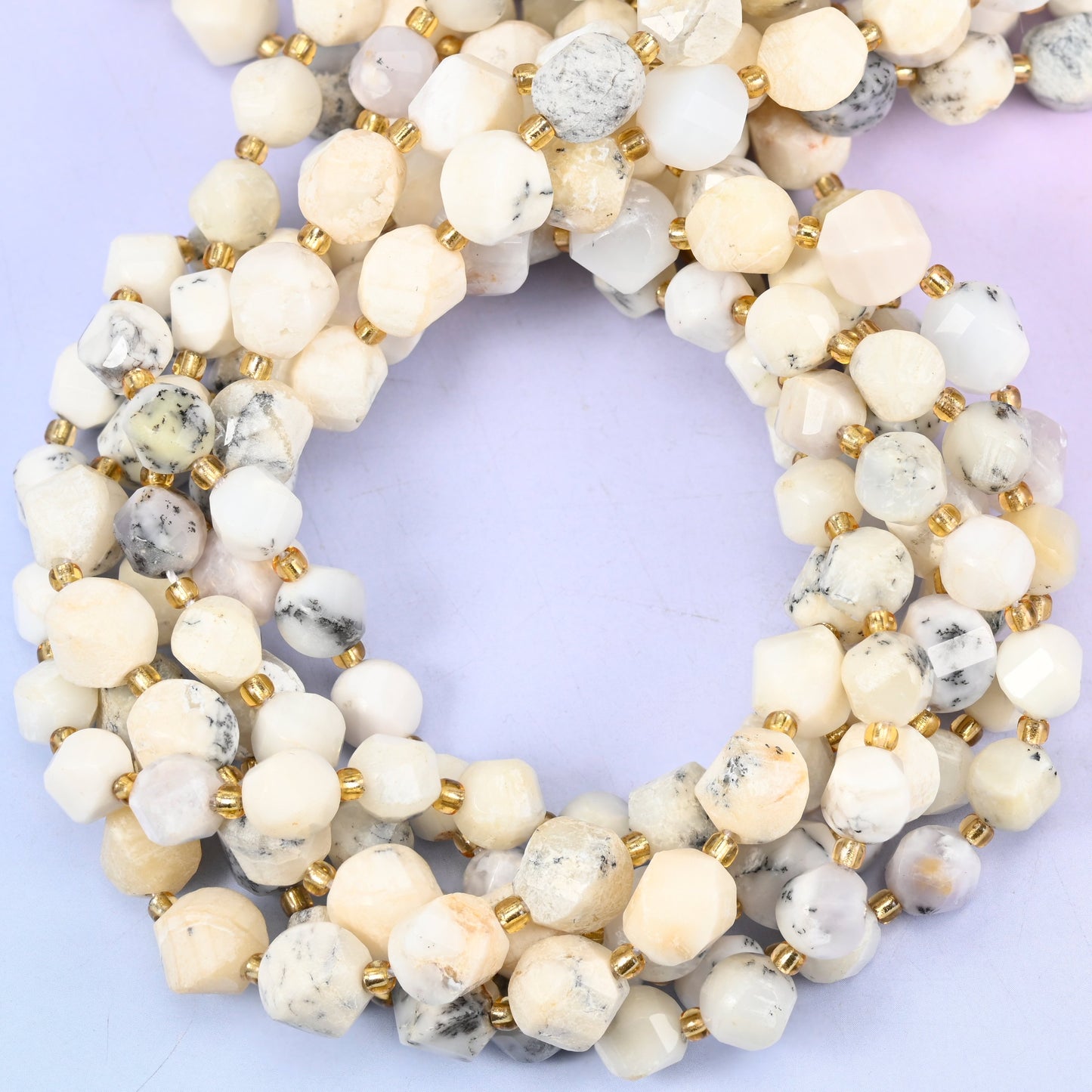 White Opal faceted spiral twist beads, close view of the coiled strands in cream and white with grey speckling
