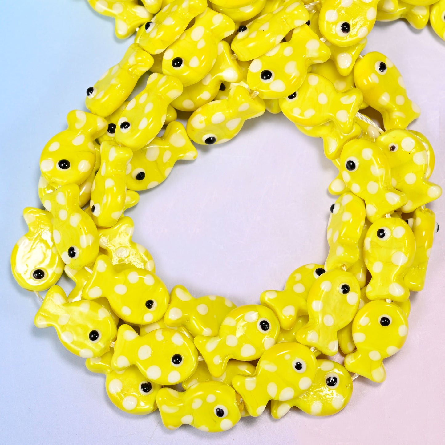 Yellow with White Dot Fish glass beads, close view of the coiled strands in bright yellow with white spots