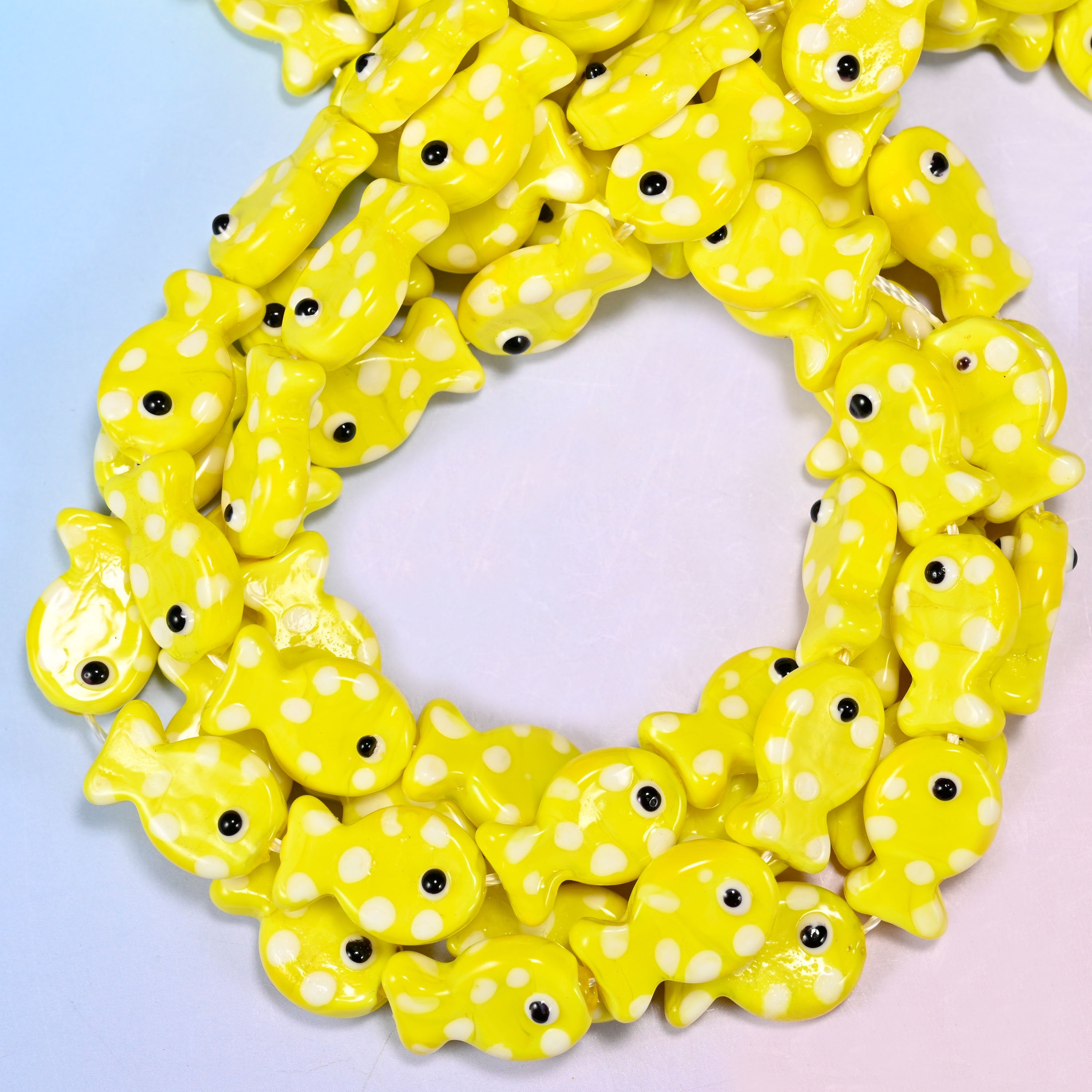 Yellow with White Dot Fish glass beads, close view of the coiled strands in bright yellow with white spots