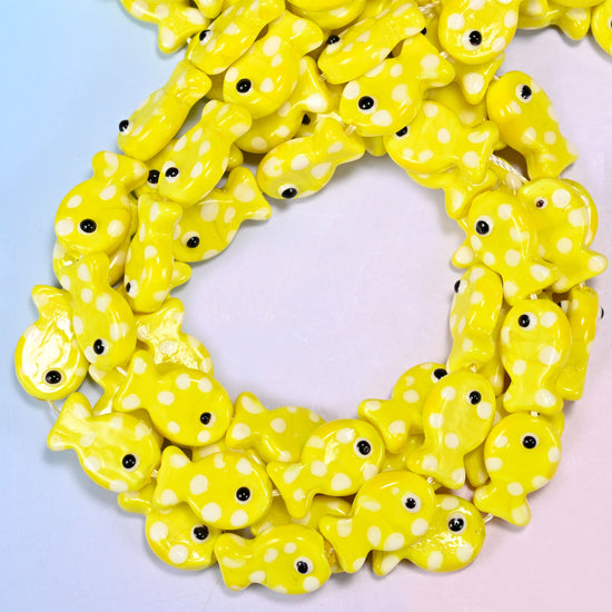 Yellow with White Dot Fish glass beads, close view of the coiled strands in bright yellow with white spots